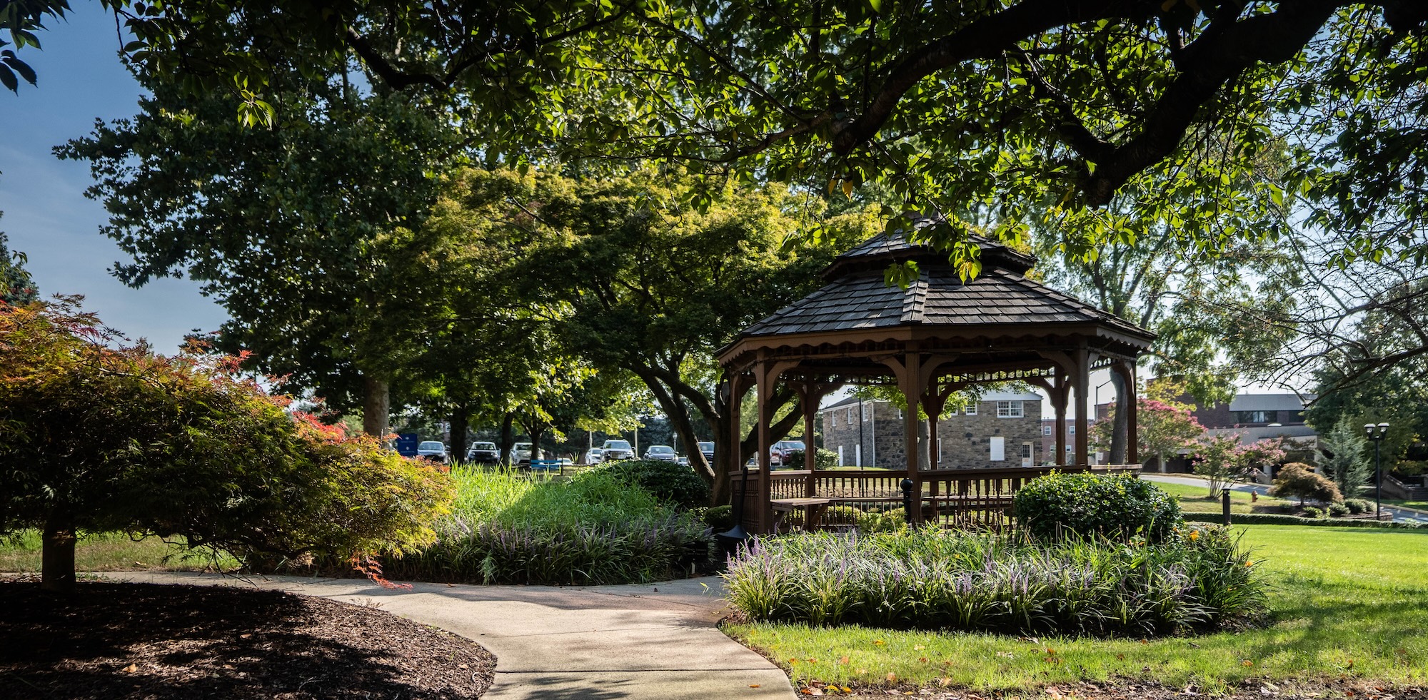 Walking path on campus, leading to a gazebo