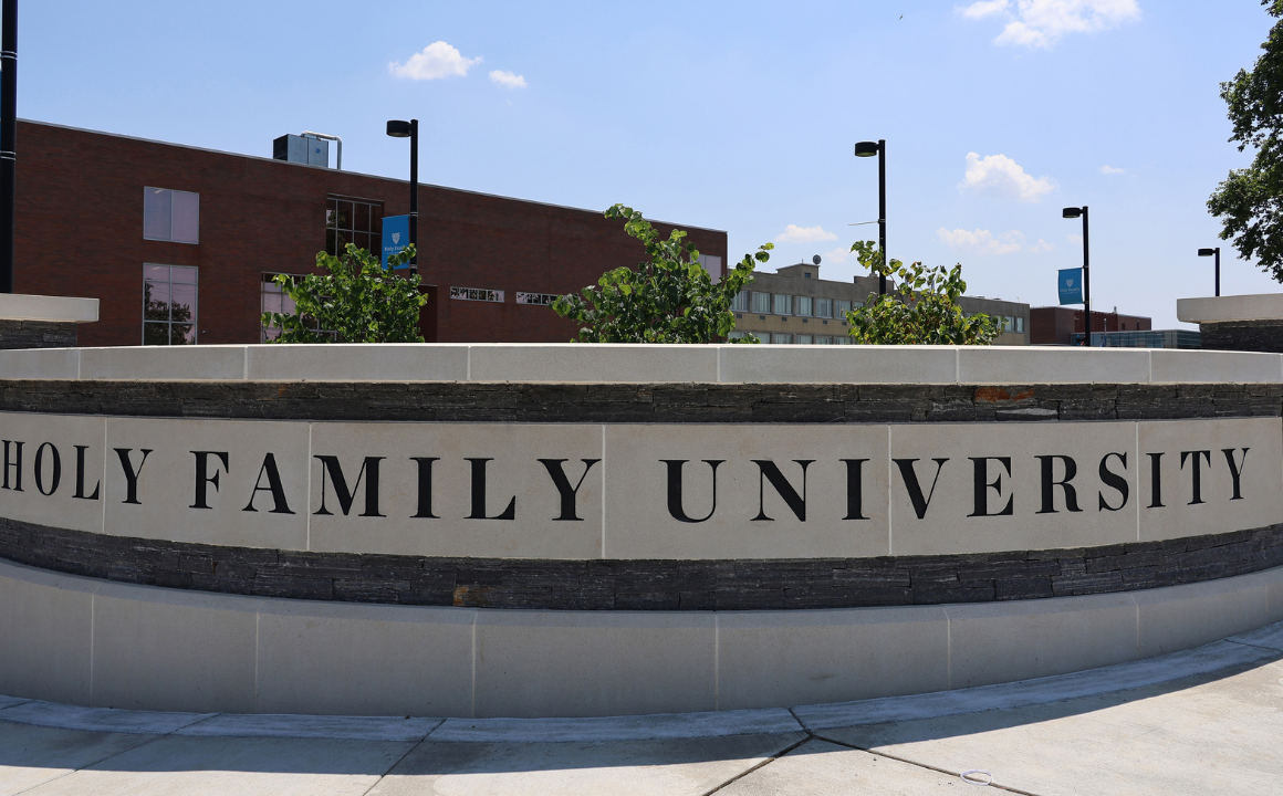 A wall by the entrance to campus with 